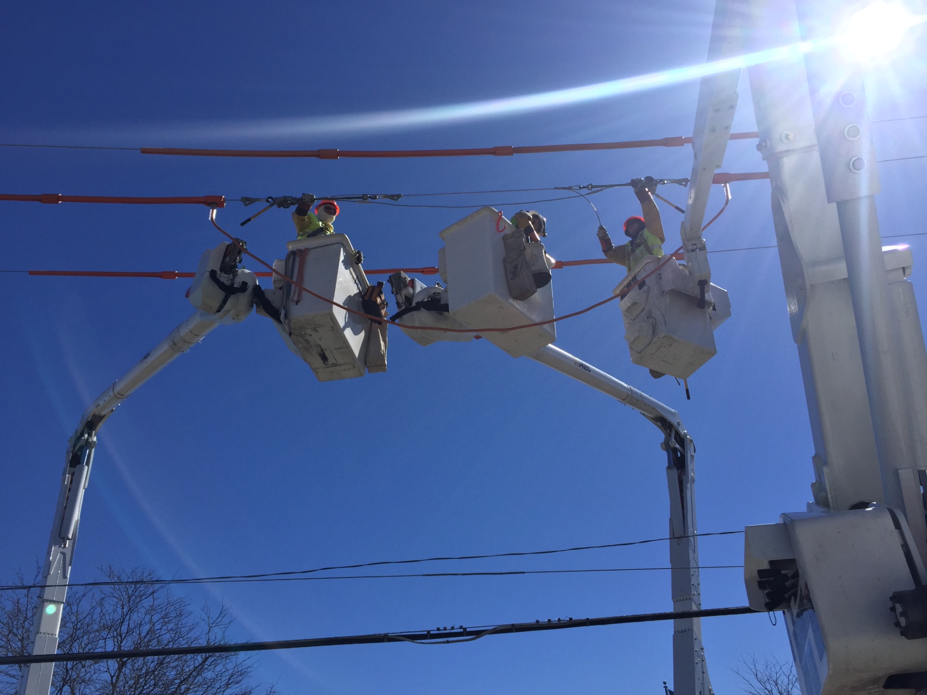 Rubber-glove crew rebuilding an overhead span